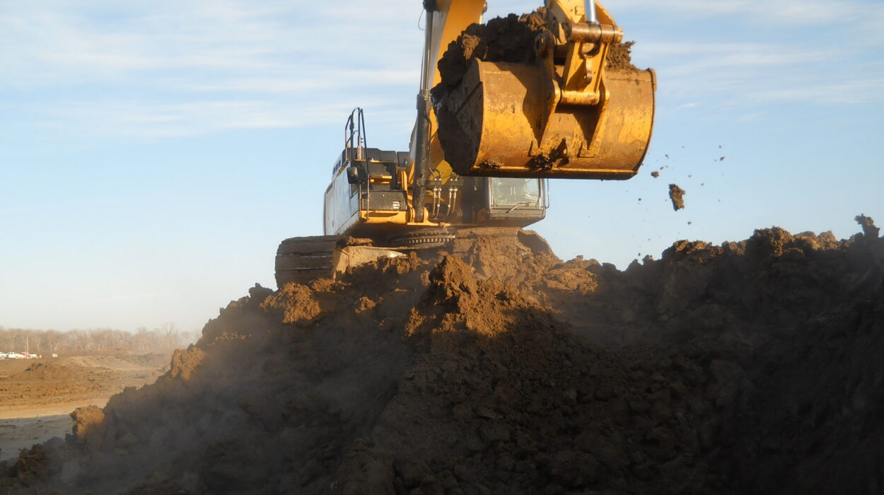 Photo of excavator in Kaufman, Texas working on levee in dirt pile