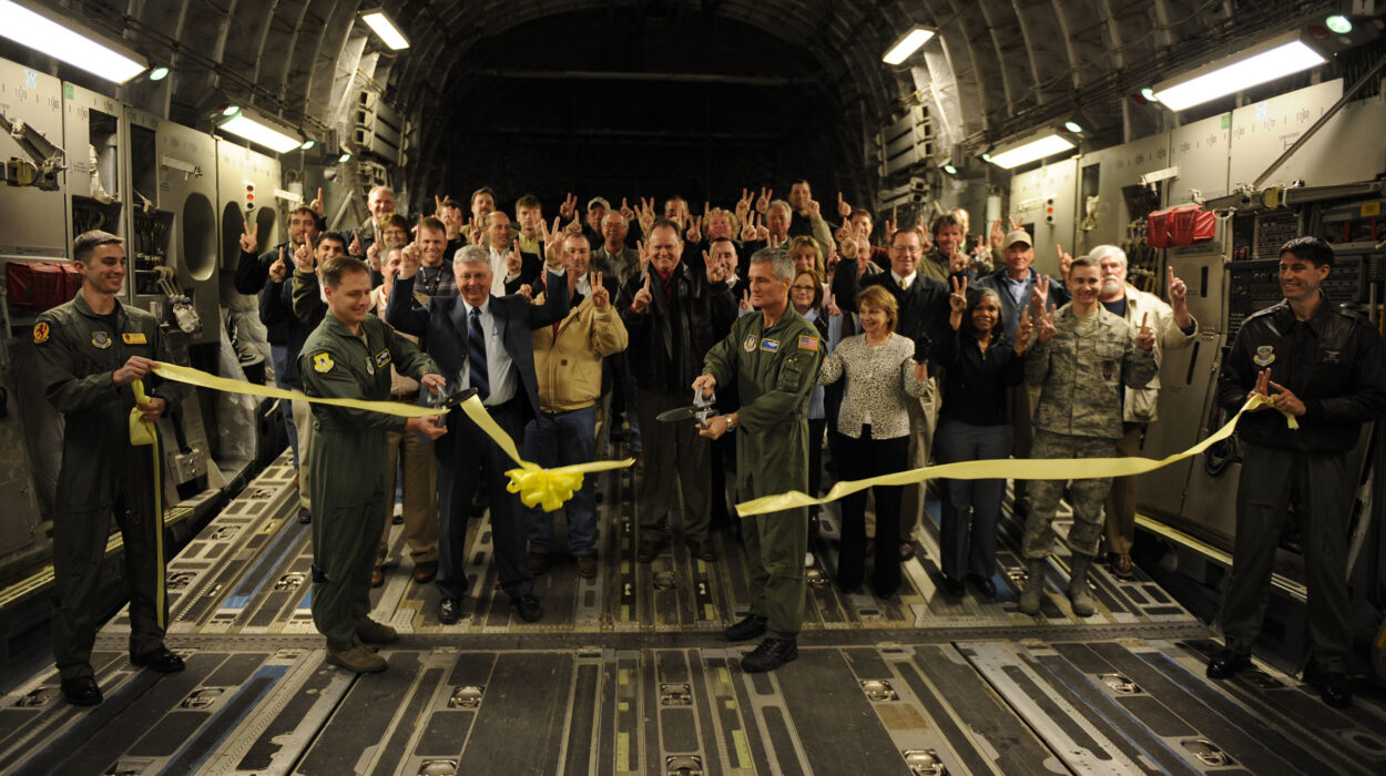 Photo of U.S. Air Force Col. John Wood, 437th Airlift Wing commander, and Col. Steven Chapman, 315th Airlift Wing commander, cut the ribbon to officially reopen runway 03/21 as they prepare for takeoff at Joint Base Charleston, S.C., Feb. 25, 2010. The flight was the first to take off and land on runway 03/21 after a reconstruction project began April 9, 2009. (U.S. Air Force photo by Staff Sgt. Eric Harris/Reviewed)
