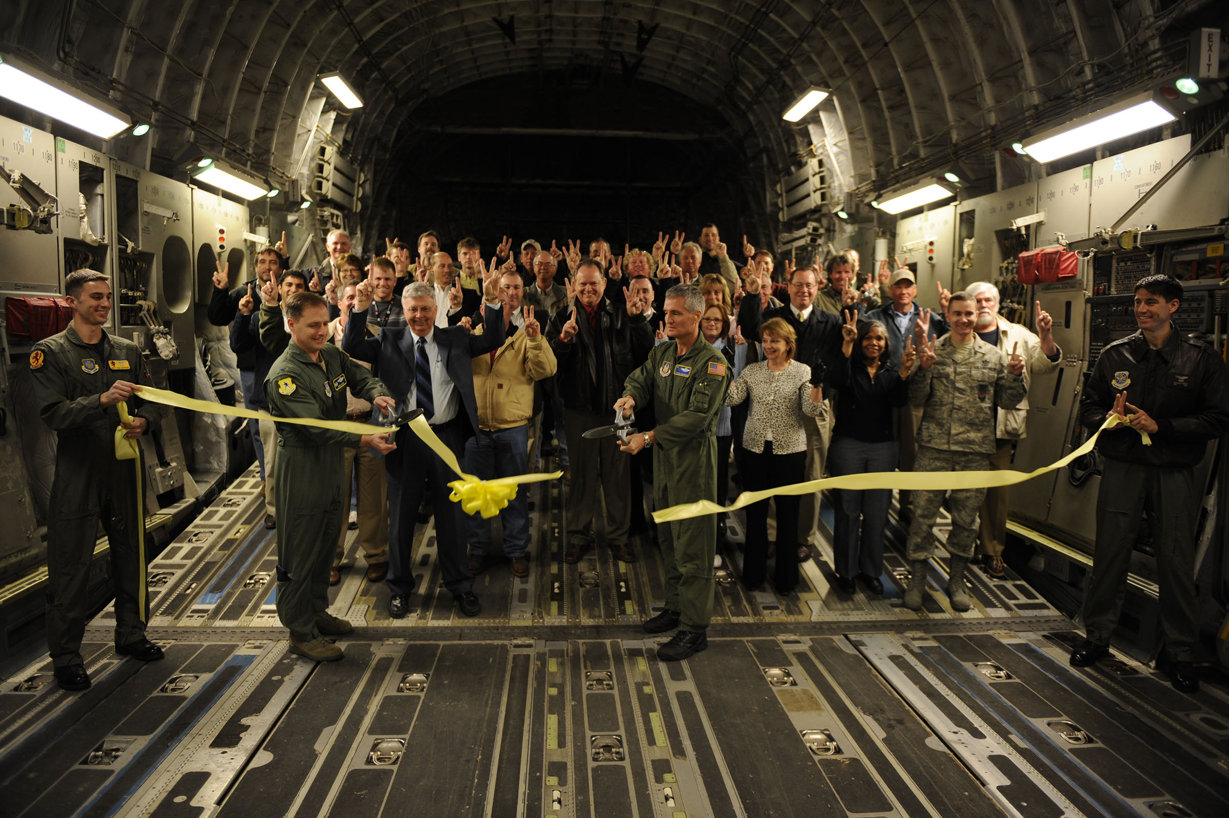 Photo of U.S. Air Force Col. John Wood, 437th Airlift Wing commander, and Col. Steven Chapman, 315th Airlift Wing commander, cut the ribbon to officially reopen runway 03/21 as they prepare for takeoff at Joint Base Charleston, S.C., Feb. 25, 2010. The flight was the first to take off and land on runway 03/21 after a reconstruction project began April 9, 2009. (U.S. Air Force photo by Staff Sgt. Eric Harris/Reviewed)