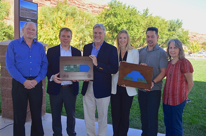 Team of people from Moab holding plaque for 10 million tons