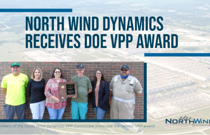 Image with employees holding award. Texts says North Wind Synamics Receives DOE VPP Award
