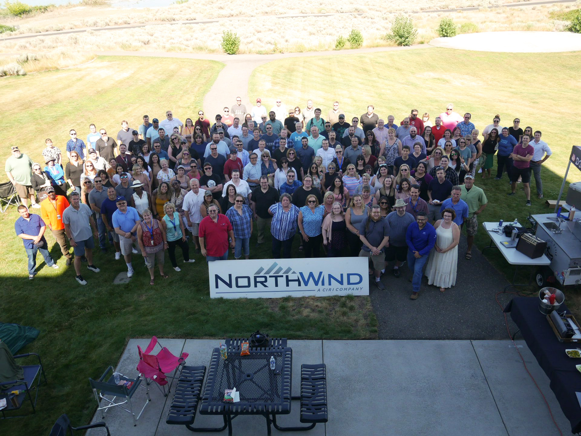 Aerial shot of employees in front of a North Wind sign