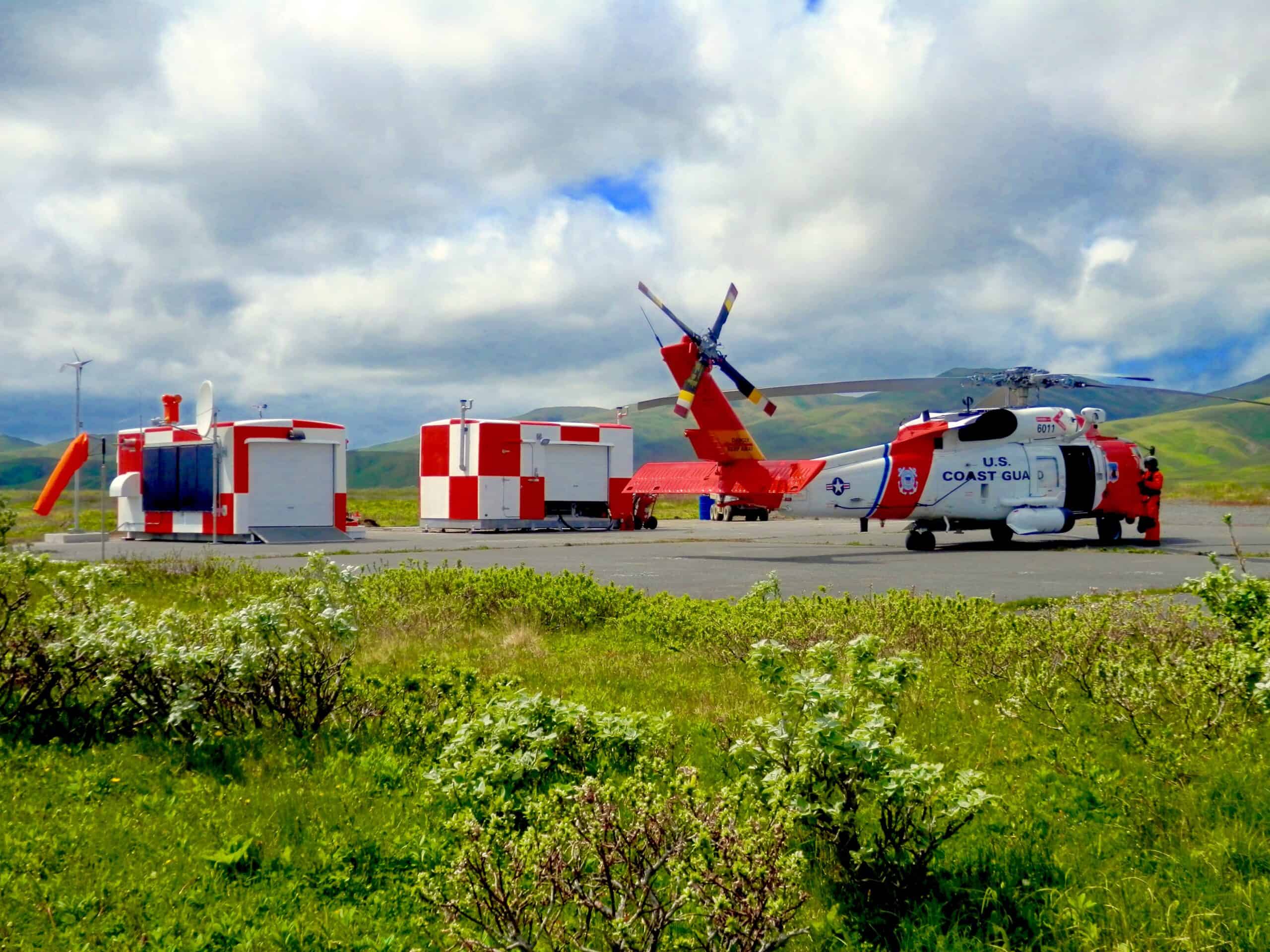 Photo of helicopter and two red and white containers in Sitkinak, Alaska